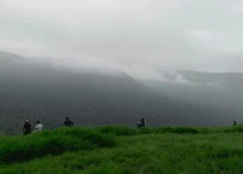 a group of people on a grassy hill with fogWeather in CambodiaClimate in Cambodia What to expect
